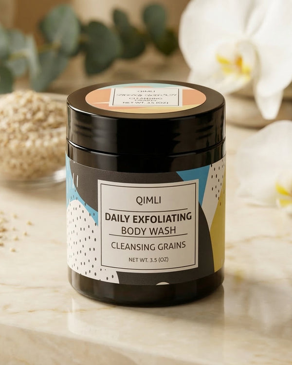 Qimli daily exfoliating body wash jar on a marble surface with decorative elements